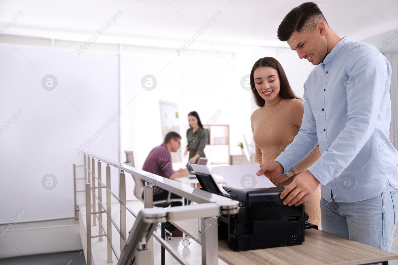 Photo of Employees using new modern printer in office