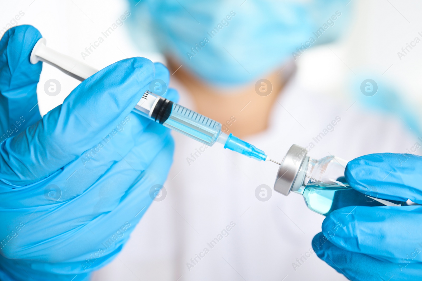 Photo of Doctor filling syringe with medication, closeup. Vaccination and immunization