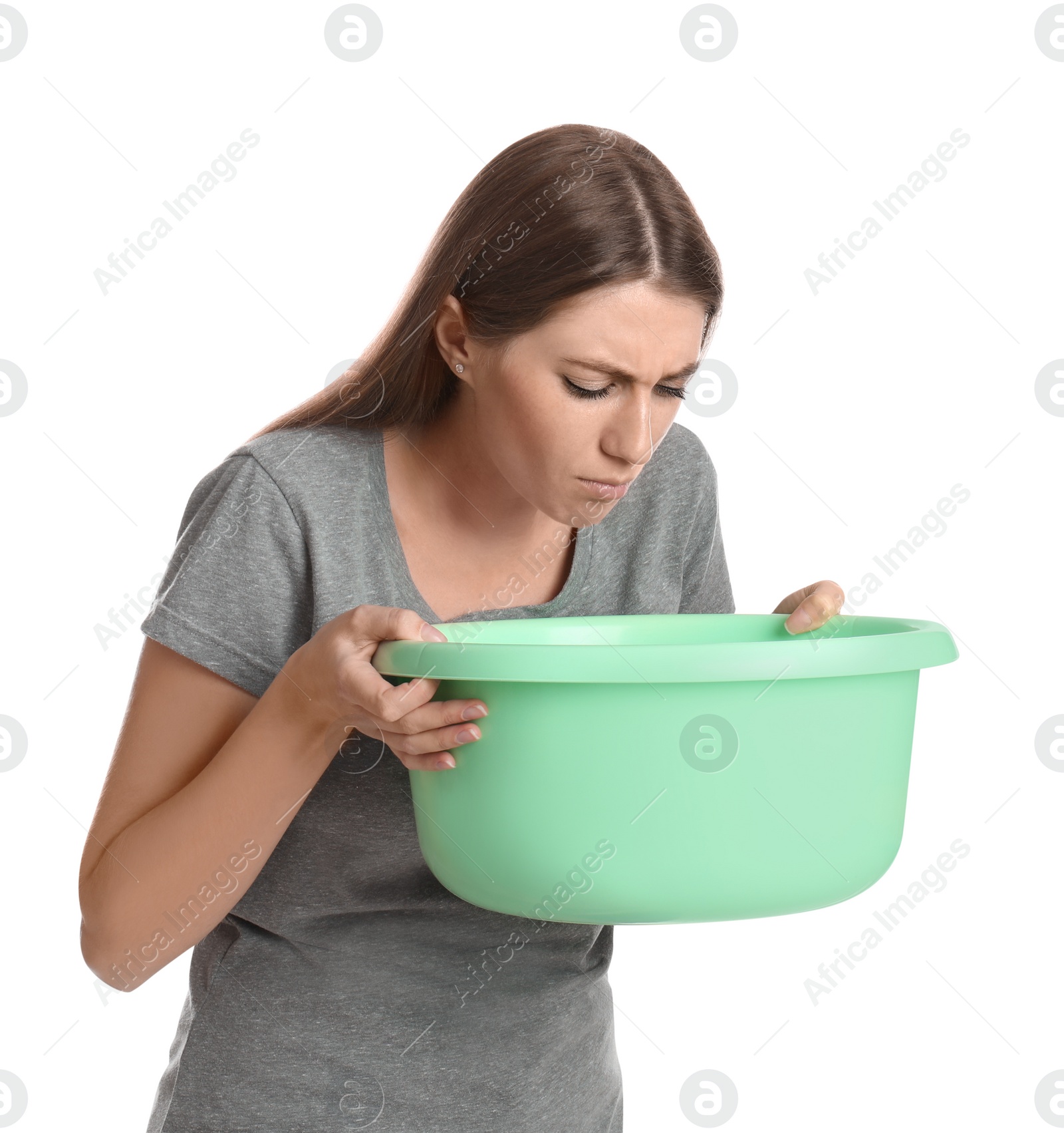 Photo of Woman with basin suffering from nausea on white background. Food poisoning