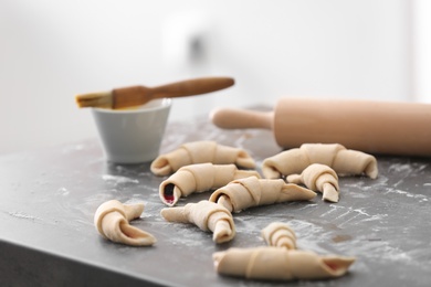 Photo of Raw croissants on kitchen table