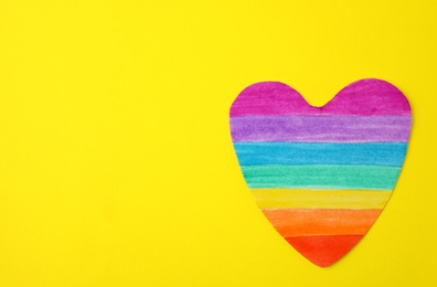 Top view of rainbow heart on color background, space for text. Gay symbol