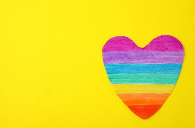 Photo of Top view of rainbow heart on color background, space for text. Gay symbol