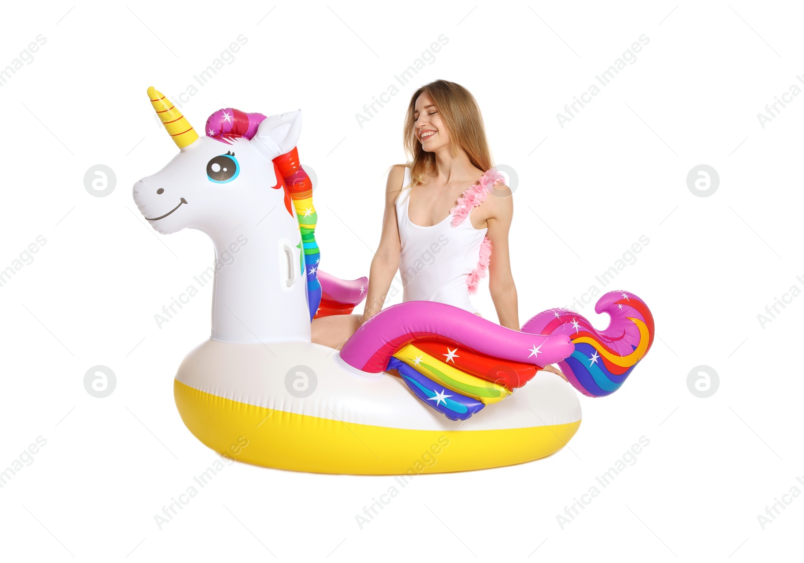 Photo of Beautiful young woman in stylish bikini with  unicorn inflatable ring on white background