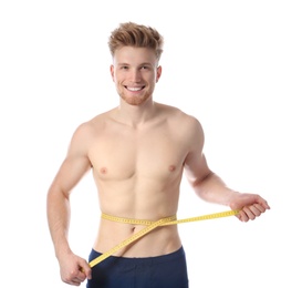 Photo of Portrait of young man with measuring tape showing his slim body on white background