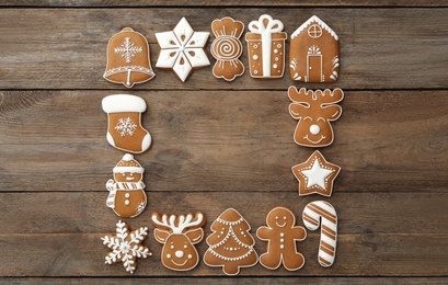 Photo of Frame of different Christmas cookies on wooden table, flat lay. Space for text