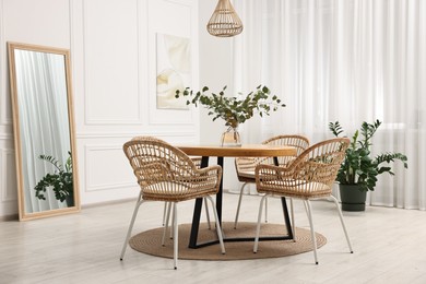 Photo of Dining room interior with comfortable furniture and plants