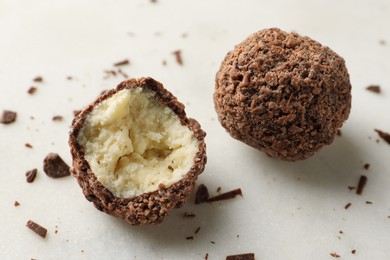 Photo of Delicious sweet chocolate truffles on white table, closeup