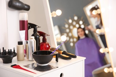 Photo of Workplace with hair dye kit in beauty salon