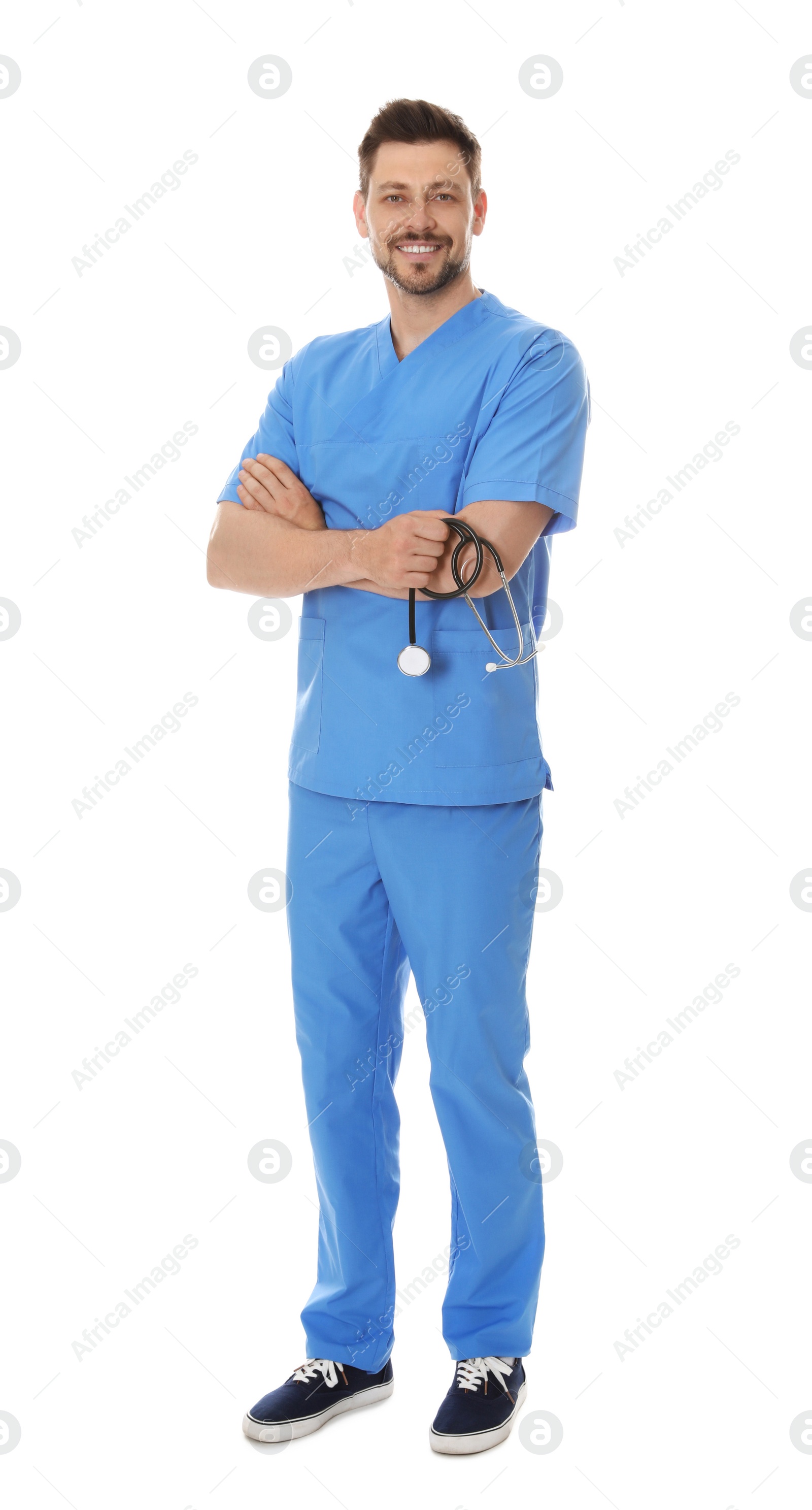 Photo of Full length portrait of smiling male doctor in scrubs isolated on white. Medical staff