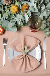Photo of Autumn table setting with eucalyptus branches and pumpkins, flat lay