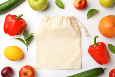 Photo of Cotton eco bag, fruits and vegetables on white background, top view