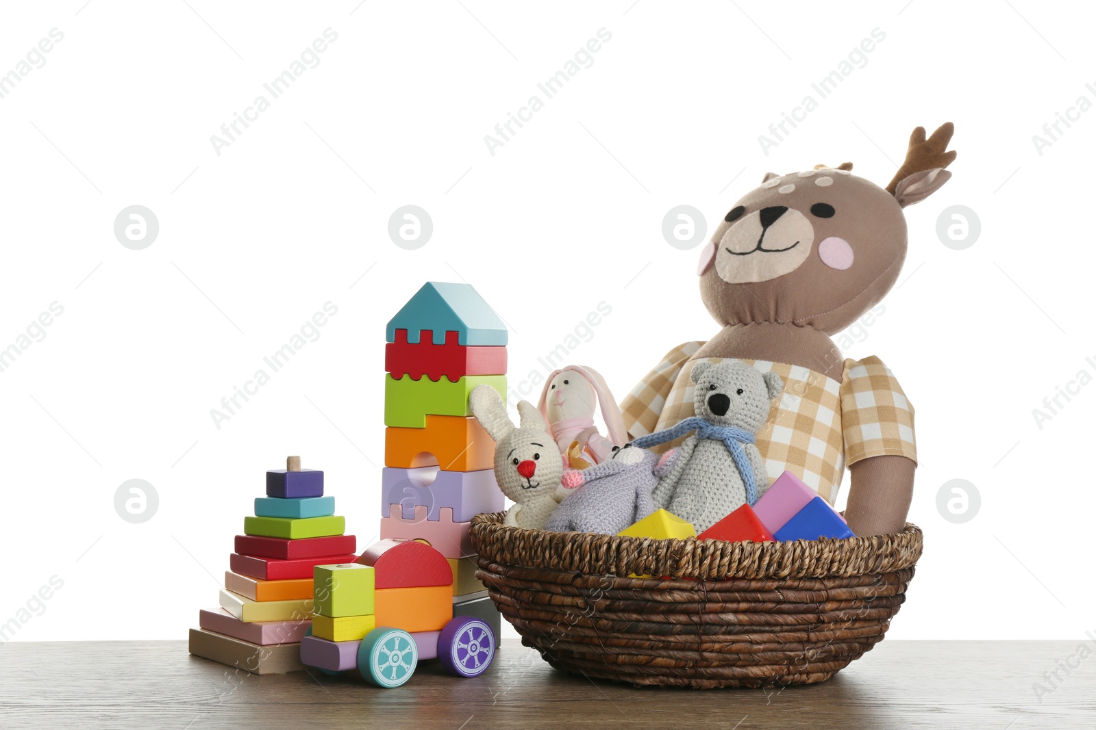 Photo of Set of different toys on wooden table against white background