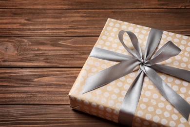 Photo of Beautiful gift box on wooden background