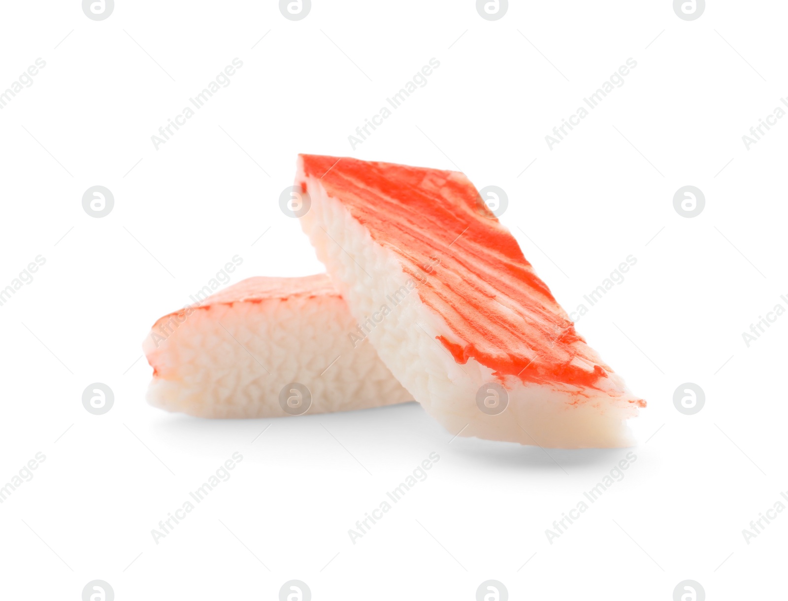 Photo of Pieces of crab stick isolated on white