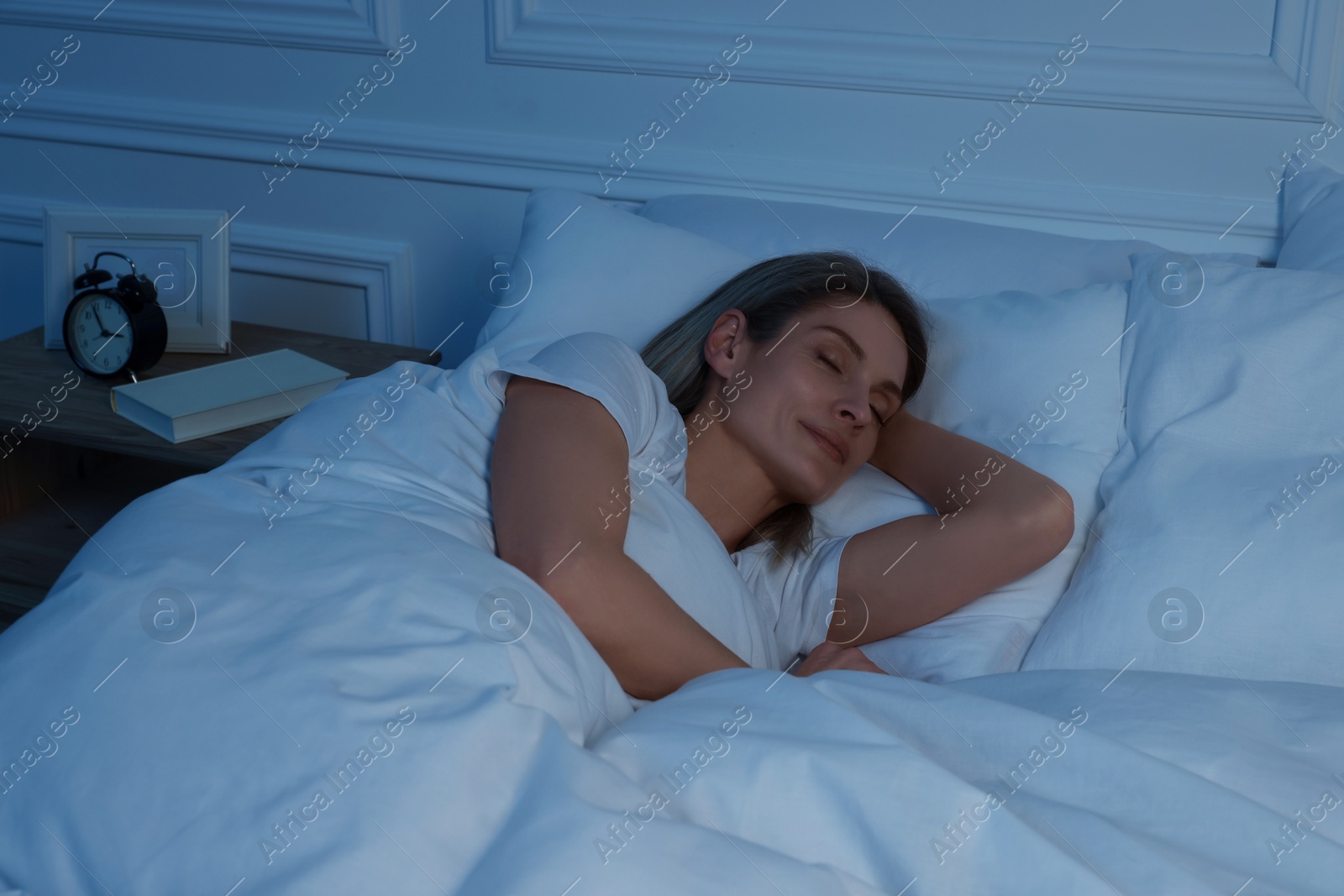 Photo of Beautiful woman sleeping in bed at night