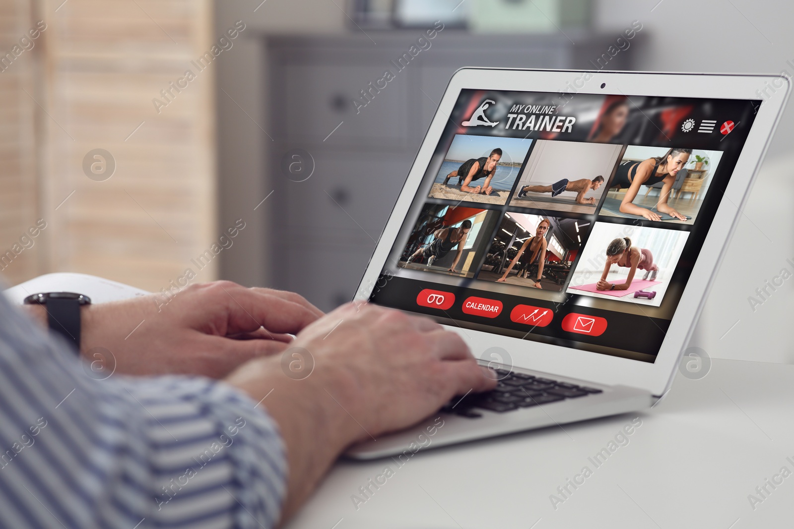 Image of Personal trainer online. Man viewing website via laptop at home, closeup