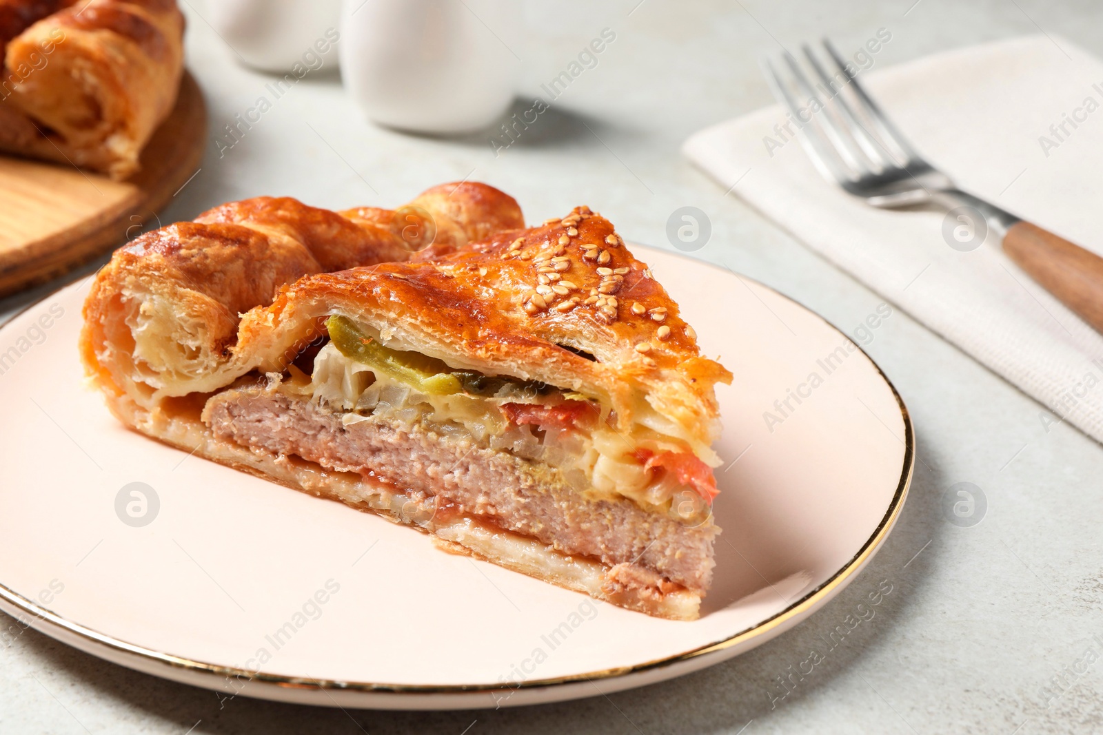 Photo of Piece of tasty homemade pie with filling on light grey table