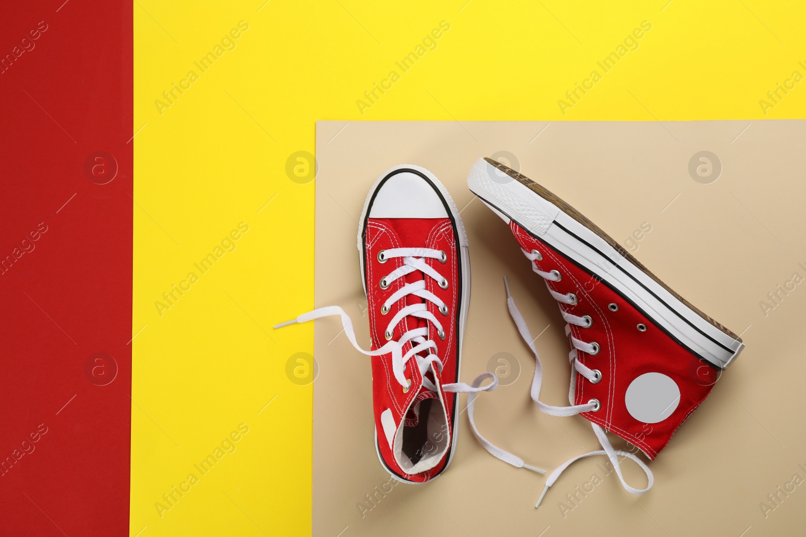 Photo of Stylish sneakers on color background, flat lay