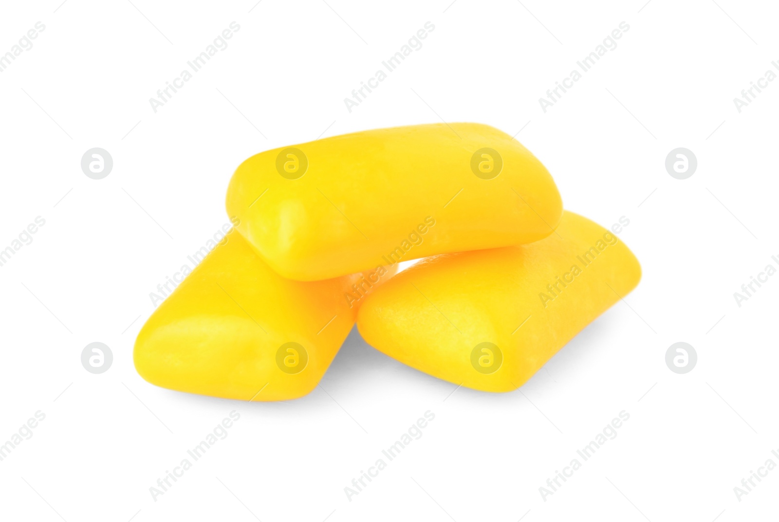 Photo of Tasty yellow chewing gums isolated on white