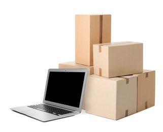 Image of Online selling. Laptop and parcels on white background