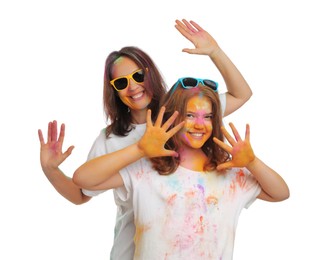 Photo of Woman and teen girl covered with colorful powder dyes on white background. Holi festival celebration