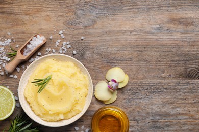 Photo of Flat lay composition with body scrub on wooden table, space for text