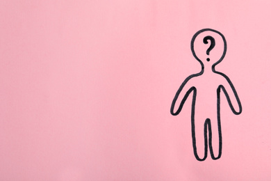 Photo of Picture of human figure with question mark in head on pink background, top view. Space for text