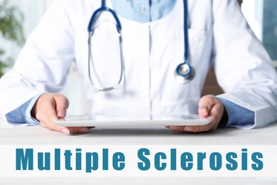 Multiple Sclerosis concept. Doctor with modern tablet sitting at table indoors, closeup