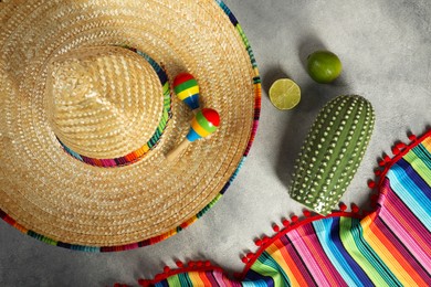 Photo of Flat lay composition with Mexican sombrero hat and maracas on grey textured table
