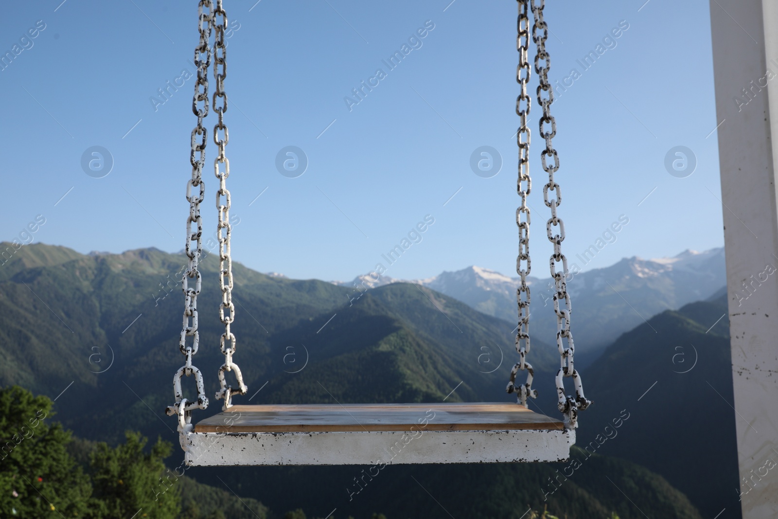 Photo of Outdoor metal swing in beautiful mountains on sunny day