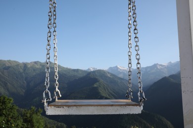 Outdoor metal swing in beautiful mountains on sunny day