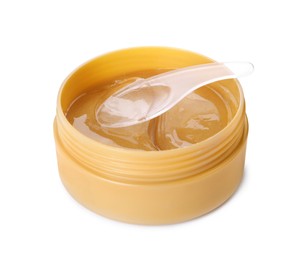 Photo of Under eye patches in jar with spatula isolated on white. Cosmetic product