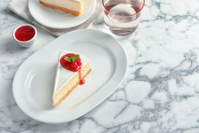 Photo of Delicious cheesecake served with sweet jam on plate