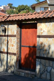 Wooden door with intercom outdoors. Private property