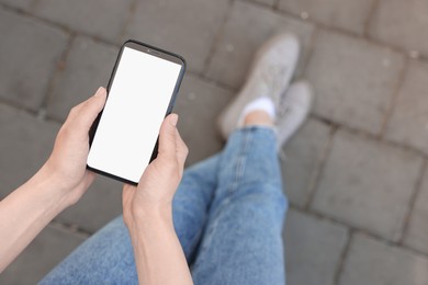 Photo of Woman using mobile phone outdoors, closeup. Space for text