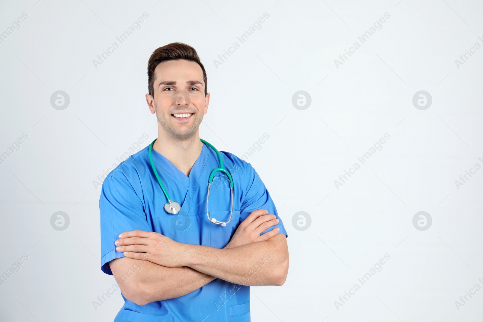 Photo of Portrait of medical assistant with stethoscope on light background. Space for text