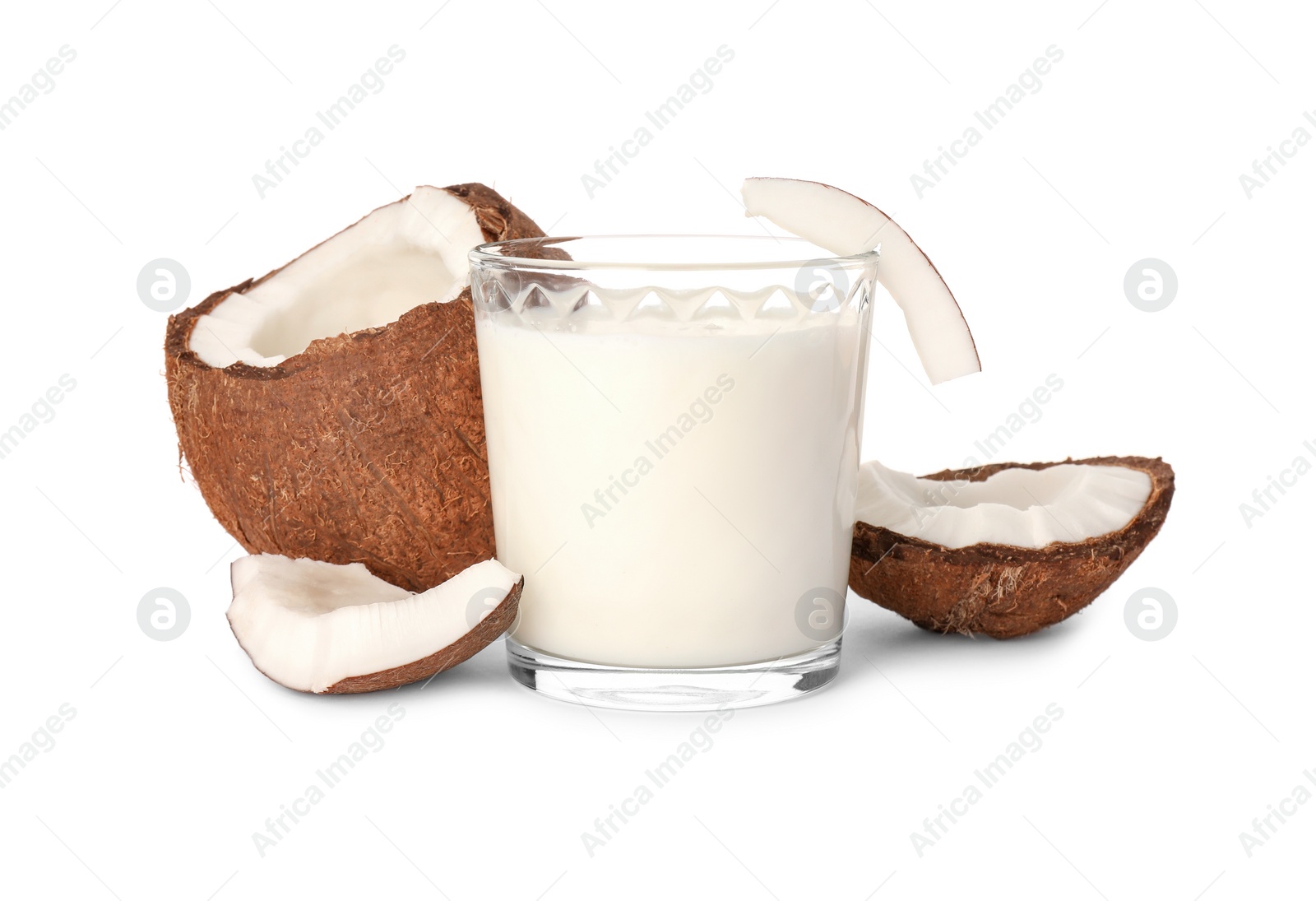 Photo of Glass of delicious vegan milk and coconut pieces on white background