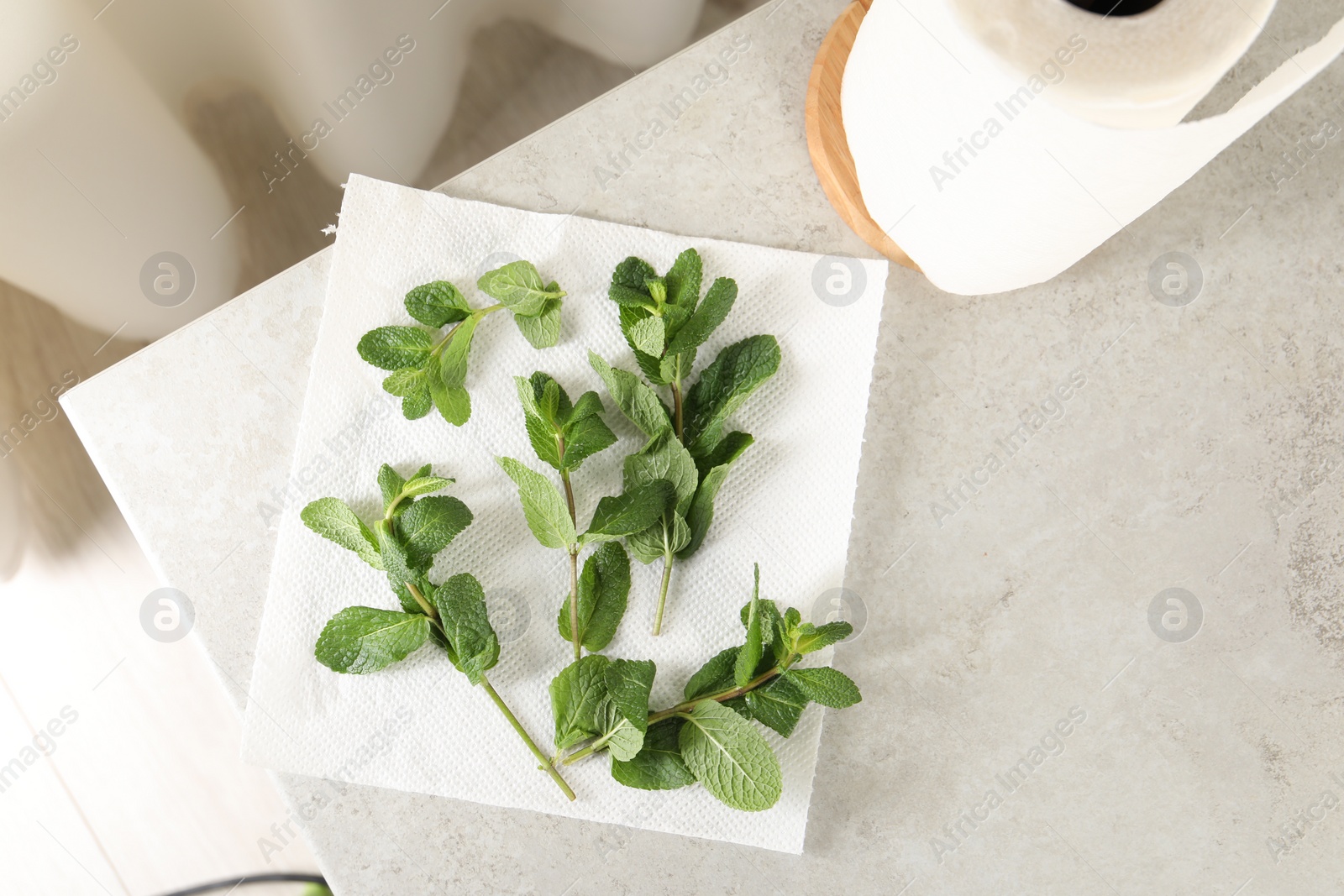 Photo of Mint drying on paper towel on light table indoors, top view