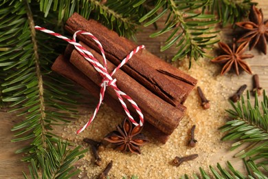 Photo of Different spices and fir branches on table, flat lay