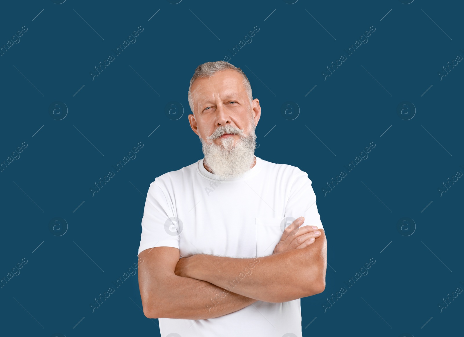 Photo of Portrait of handsome senior man on blue background