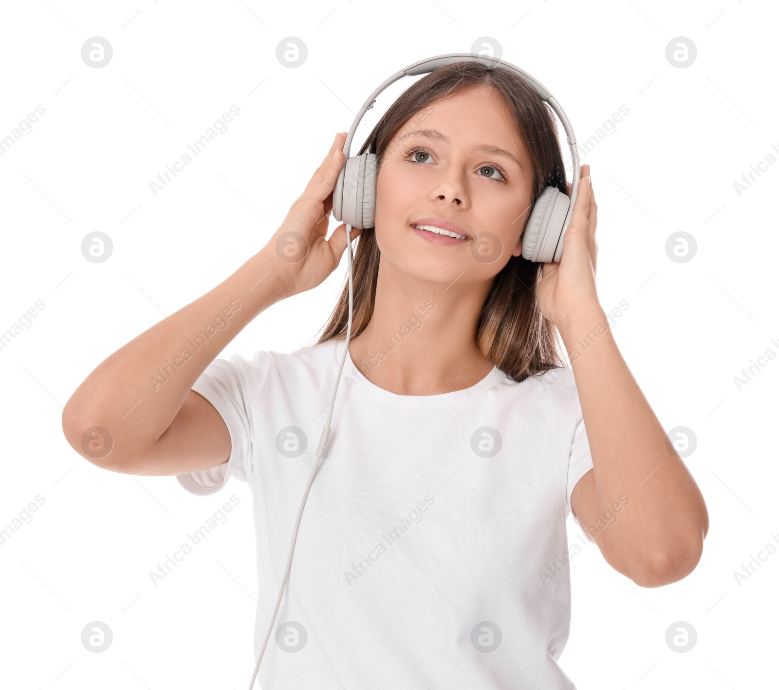 Photo of Teenage girl listening to music with headphones on white background