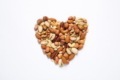 Heart made of different nuts on white background, flat lay