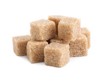 Photo of Many brown sugar cubes isolated on white