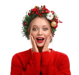 Beautiful young woman wearing Christmas wreath on white background