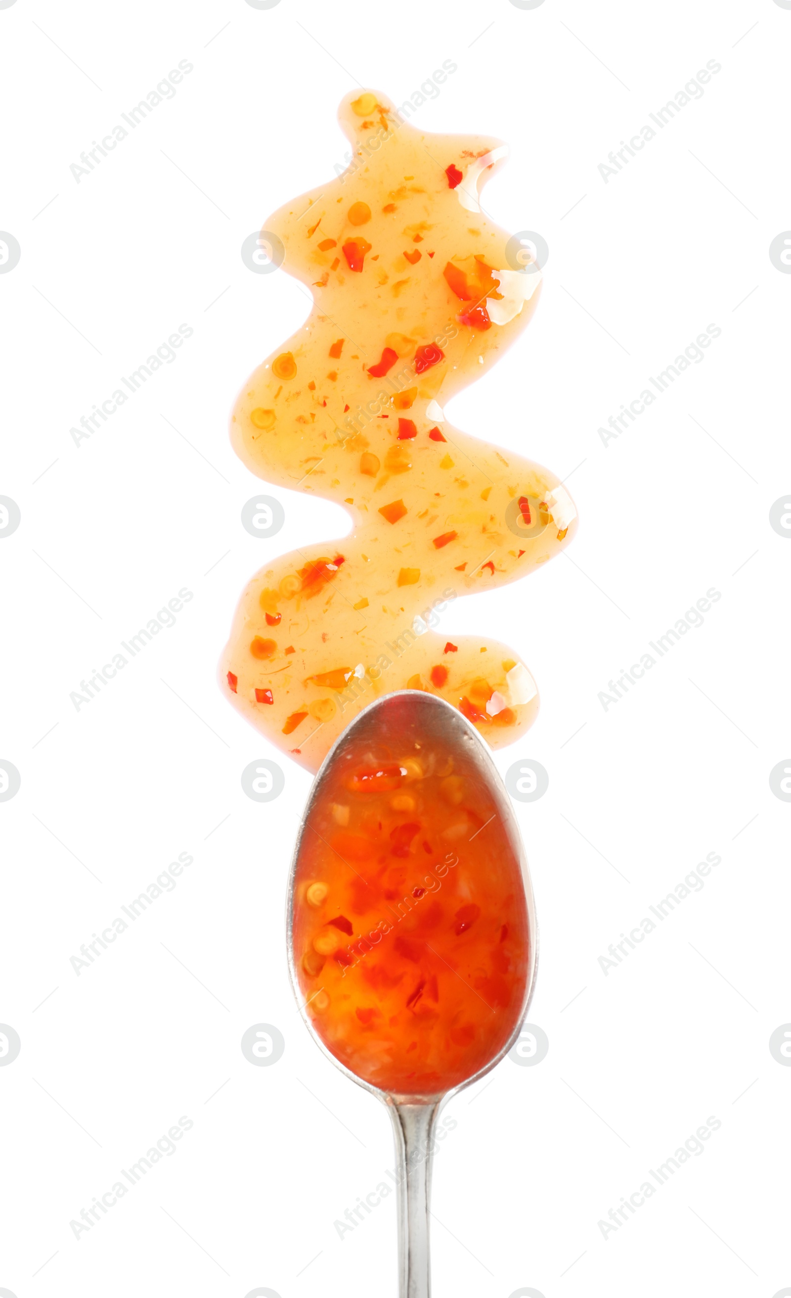 Photo of Delicious sweet chili sauce and spoon on white background, top view