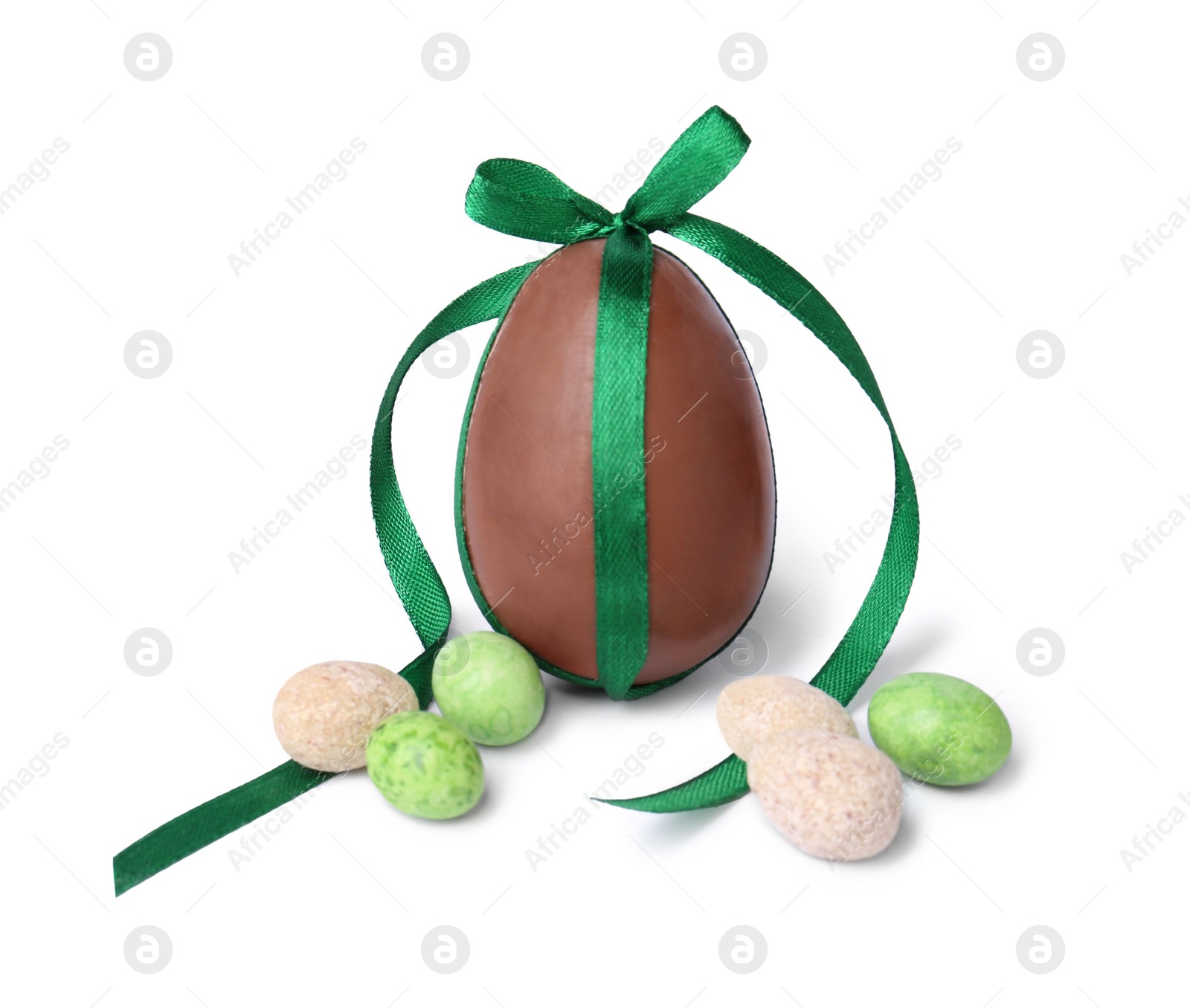 Photo of Tasty chocolate egg with green bow and different candies isolated on white