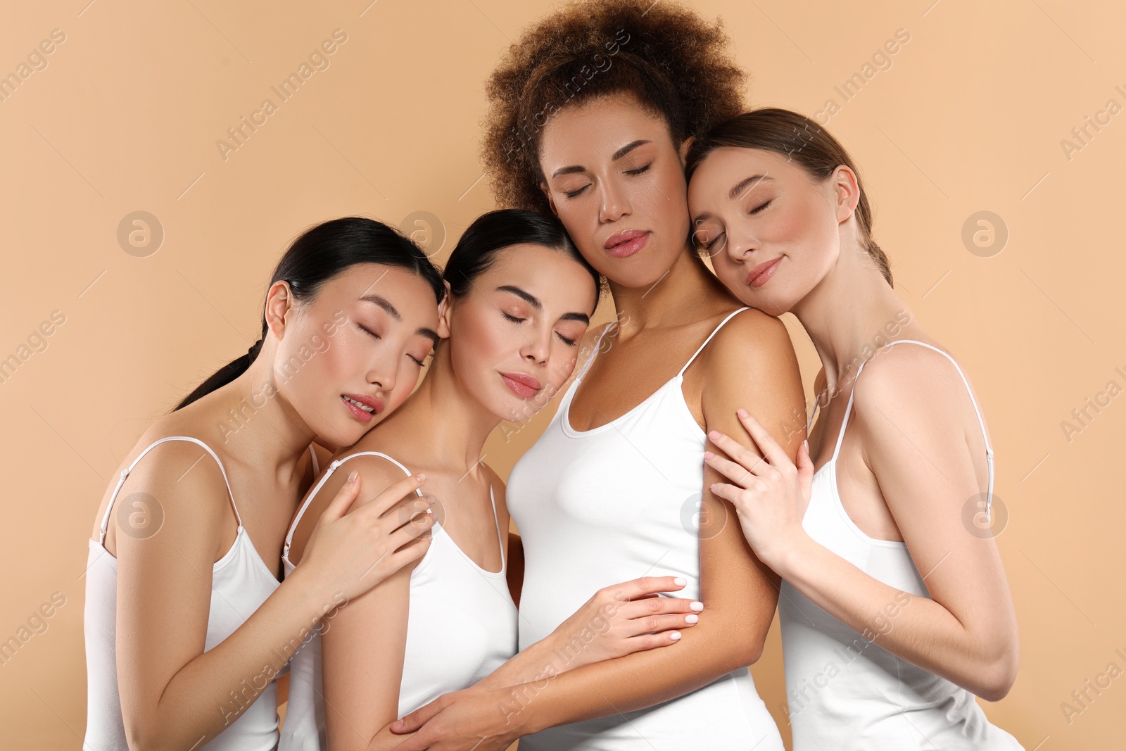 Photo of Beautiful young women with healthy skin on beige background