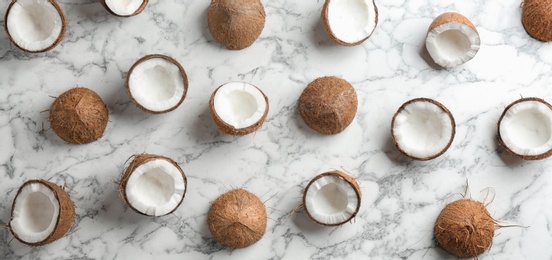 Photo of Coconut pattern on marble table, flat lay