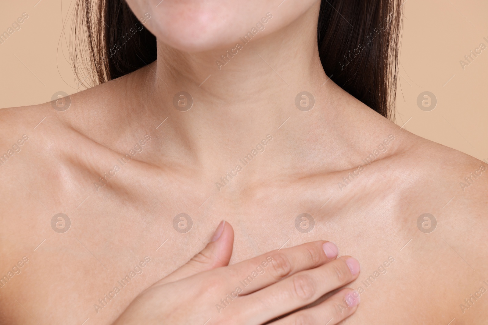 Photo of Closeup view of woman with healthy skin on beige background