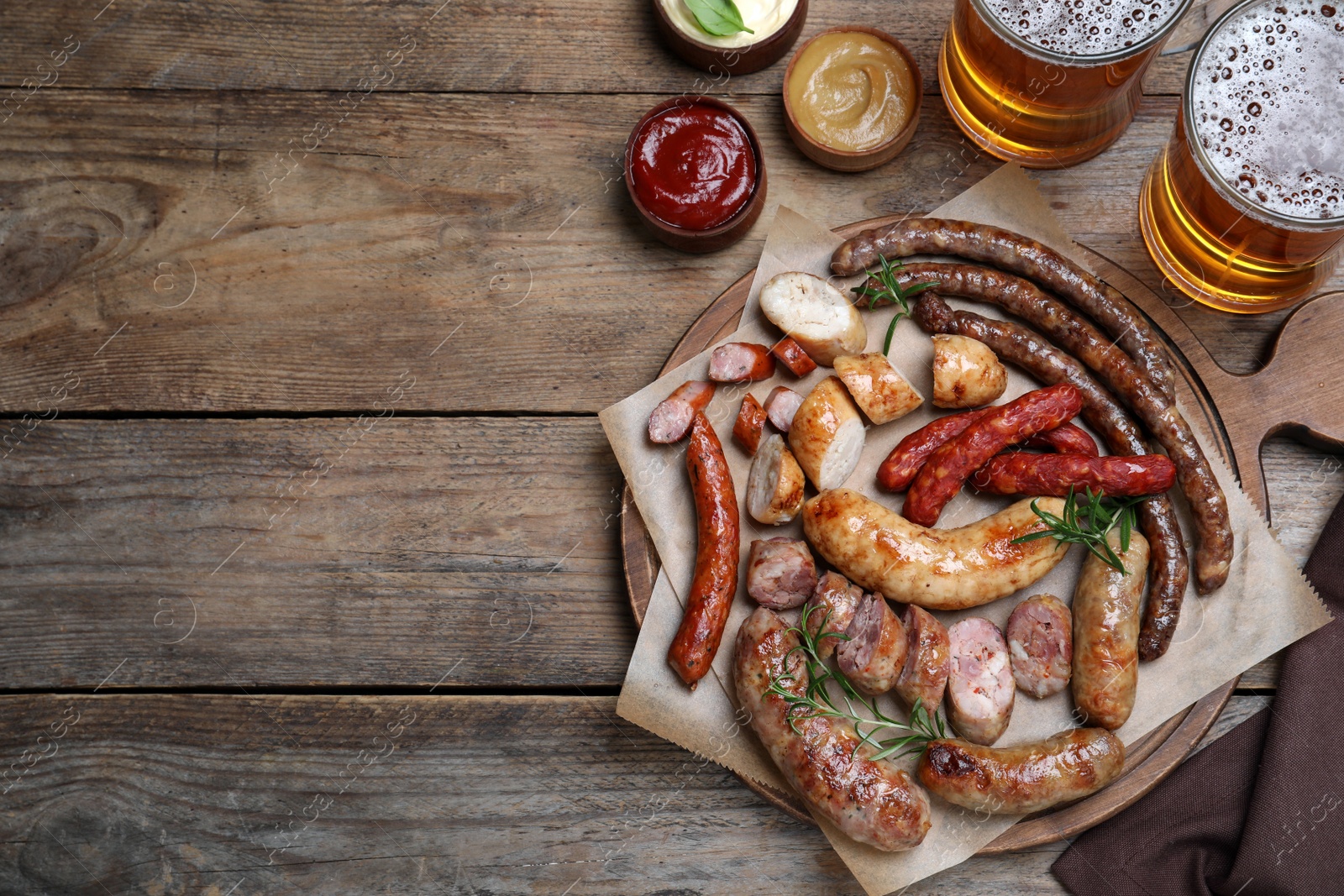 Photo of Set of different tasty snacks and beer on wooden table, flat lay. Space for text